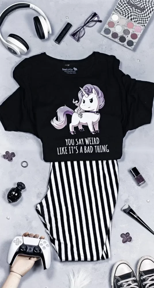 Barbie inspired outfit flat lay, black and white striped leggings with a tee turtle tshirt, converse, and a controller and headphones