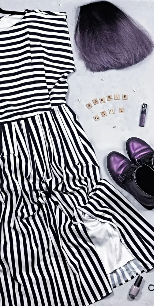 Barbie inspired outfit flat lay, black and white striped dress with purple combat boots