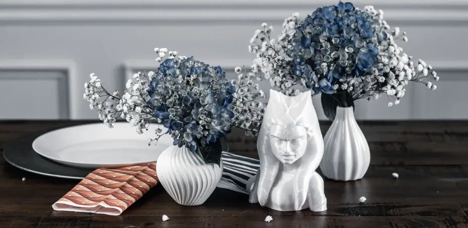 This image has an ahsoka tano bust with blue hydrangeas in white vases, original designed fabric from spoonflower, industrial chargers, and white plates on a geeky dining room table