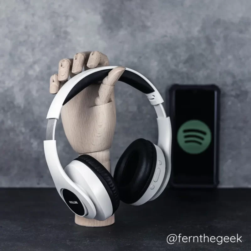 White headphones and cell phone with Spotify logo, follow fern the geek on Spotify