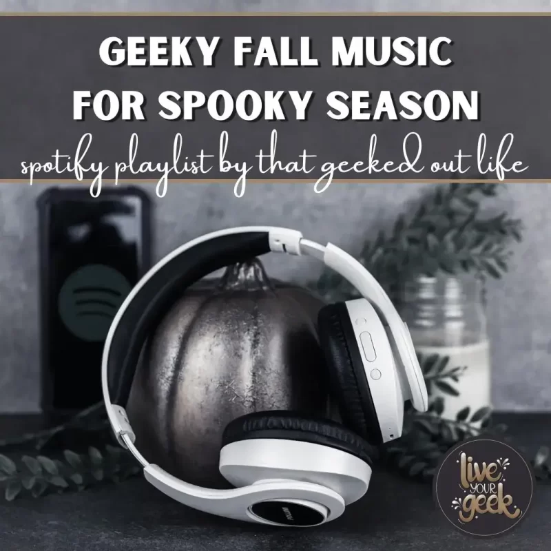 white headphones on an industrial painted pumpkin with a candle, plant, and cell phone with the Spotify logo