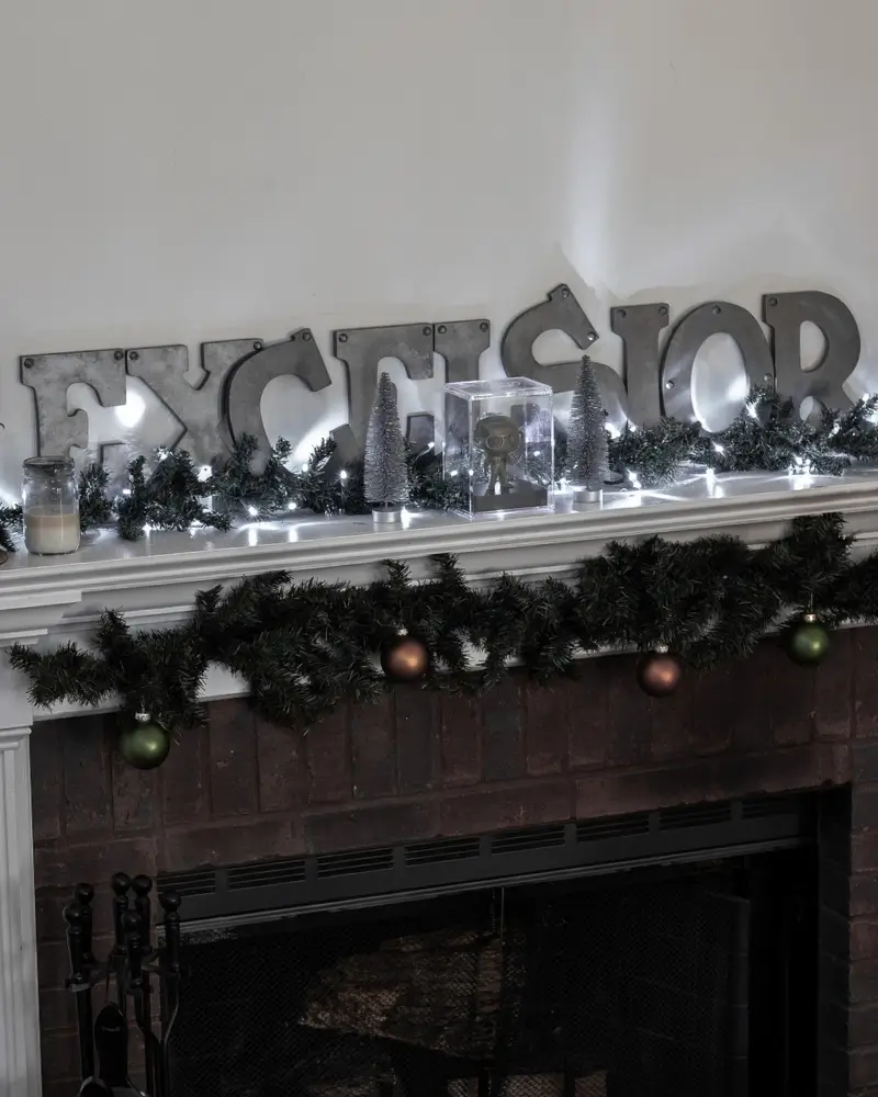 Excelsior letters on the fireplace for Stan Lee